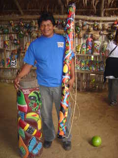 Maleku Indian with carved & painted drum and rain stick of balsa wood