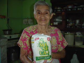 Hortensia in her Atenas, Costa Rica kitchen holding a bag of Maseca brand corn flour (masa harina)
